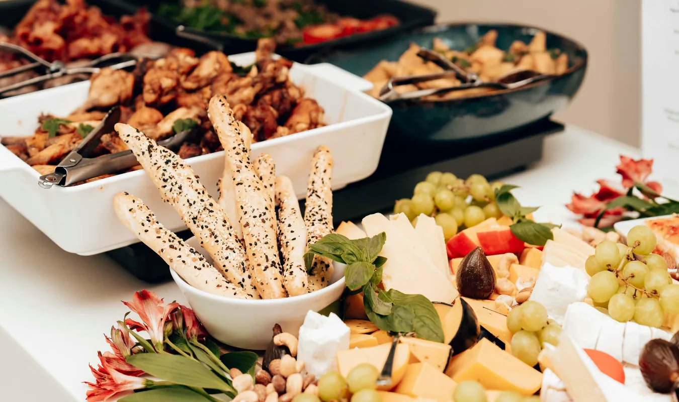 A grazing spread with breadsticks, grapes and cheeses for a shower