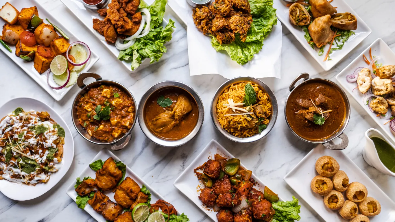 A labelled office lunch spread with vegetarian, gluten-free and meat dishes side by side