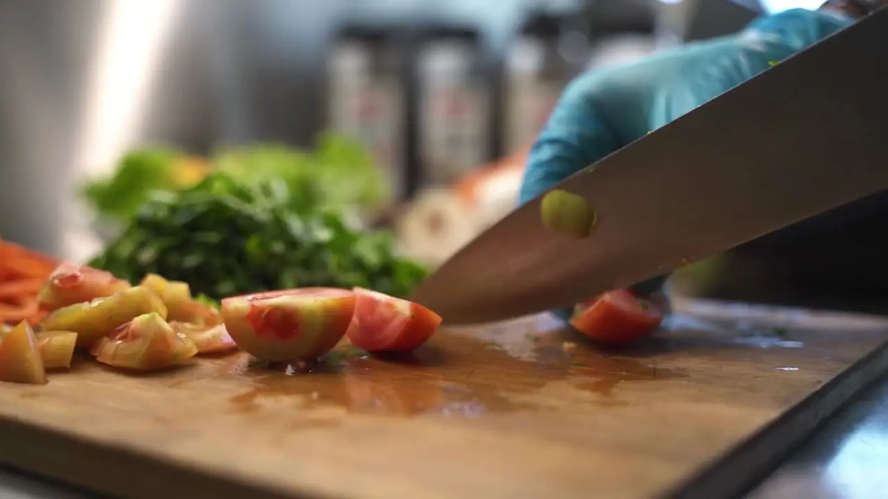 Chef Claire slicing tomatoes and chorizo on a prep board