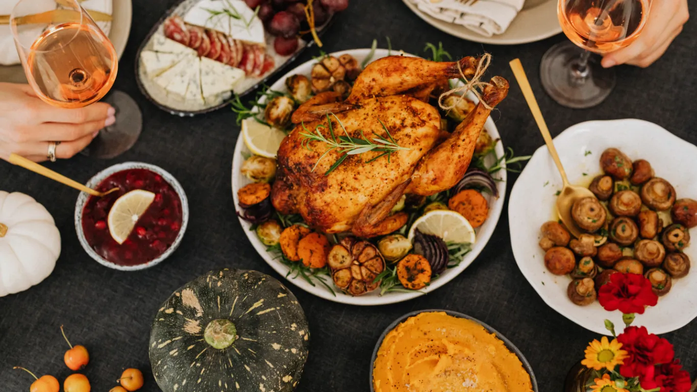 A seasonal table spread by Claire's Kitchen — roast chicken, charred vegetables, olives and dips